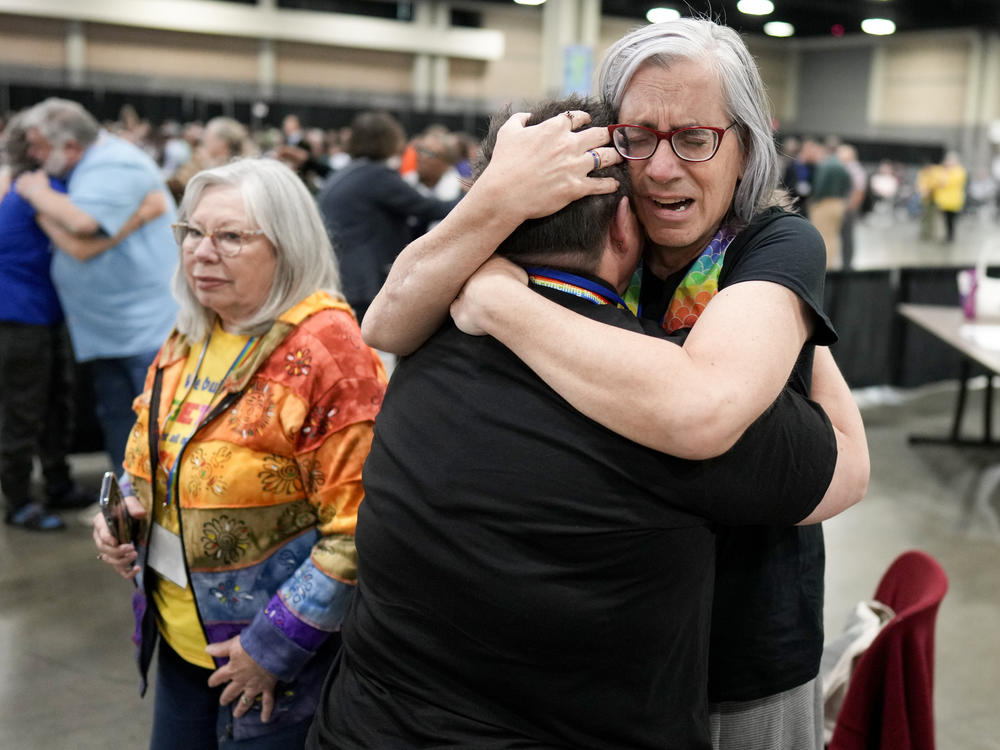 Angie Cox, left, and Joelle Henneman hug after an approval vote at the United Methodist Church General Conference that repealed their church's longstanding ban on LGBTQ clergy and same-sex weddings.