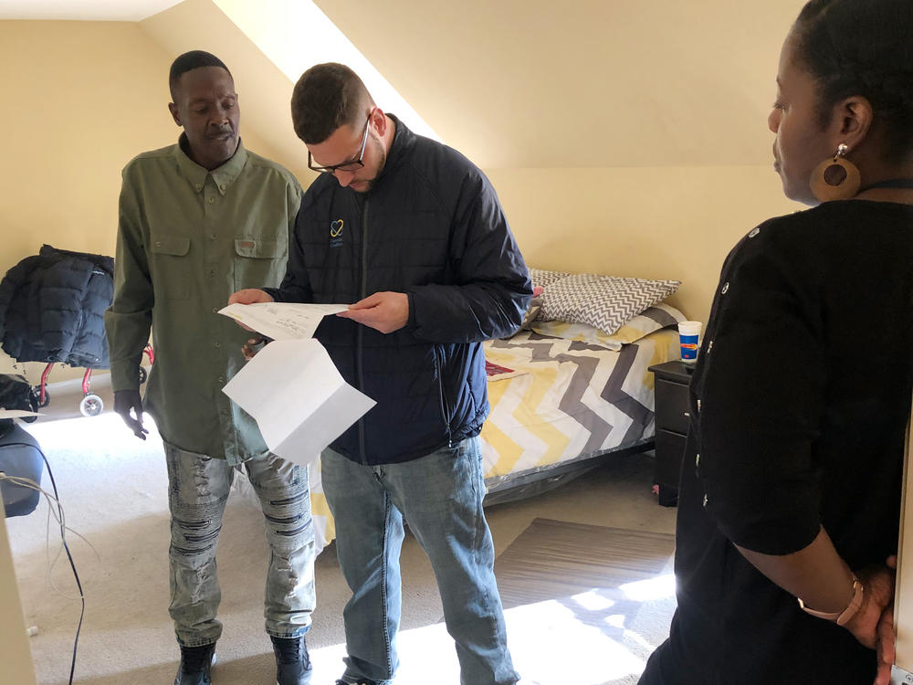 Larry Moore (left) in 2020 with staff members from the Camden Coalition. The housing and addiction treatment the organization helped him get has been life saving.