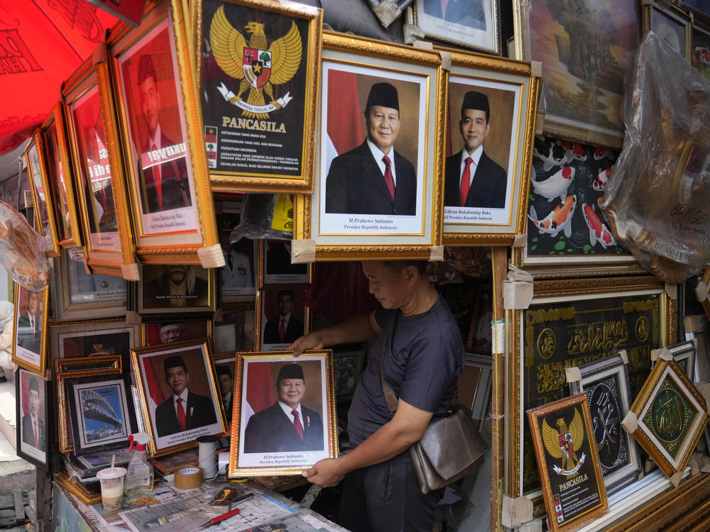 A vendor holds a portrait of Indonesian President-elect Prabowo Subianto at a market in Jakarta, Indonesia, April 24.