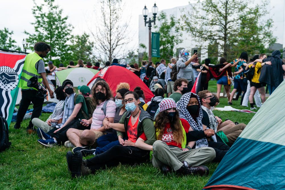 Pro-Palestinian demonstrators, who planned to stay in the encampment, link arms on April 27, at Washington University in St. Louis. Protestors marched through campus and set up an encampment in response to the university's ties to Boeing, the supplier of many weapons to Israel used in the Gaza war.
