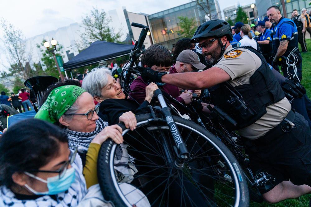 A St. Louis County police officers rams a bicycle into presidential candidate Jill Stein and other pro-Palestine demonstrators during a rally on April 27, at Washington University.