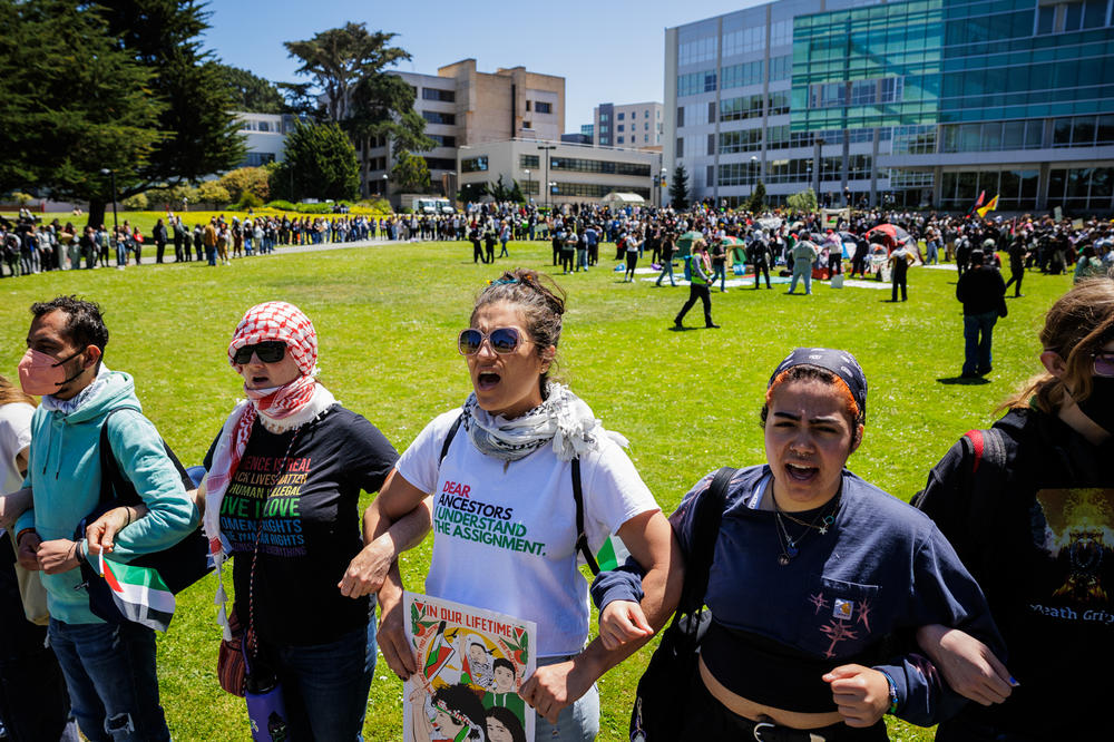 San Francisco State University students stand arm in arm as they assemble an encampment on campus to demand the university to disclose its financial ties to Israel and divest from weapons manufacturers at SFSU on April 30.