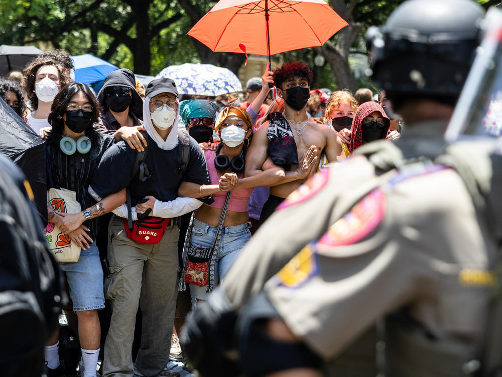 Law enforcement form a circle around the encampment of pro-Palestinian protestors on April 29, at the University of Texas at Austin.