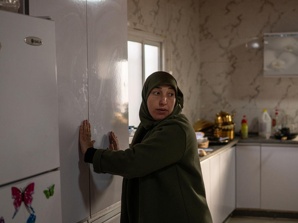 Mayada Abu Queider stands in her kitchen. She says her children were hiding under a table during the Oct. 7 attack because the village did not have a rocket shelter.