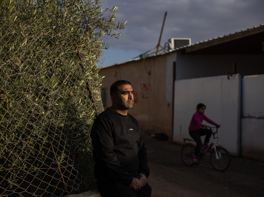Mohammad Abu Queider stands near his home in al-Zarnuq, an unrecognized Bedouin village in southern Israel. His family has been caught in the crossfire twice: first during the Hamas attack and then in the Iranian strike.