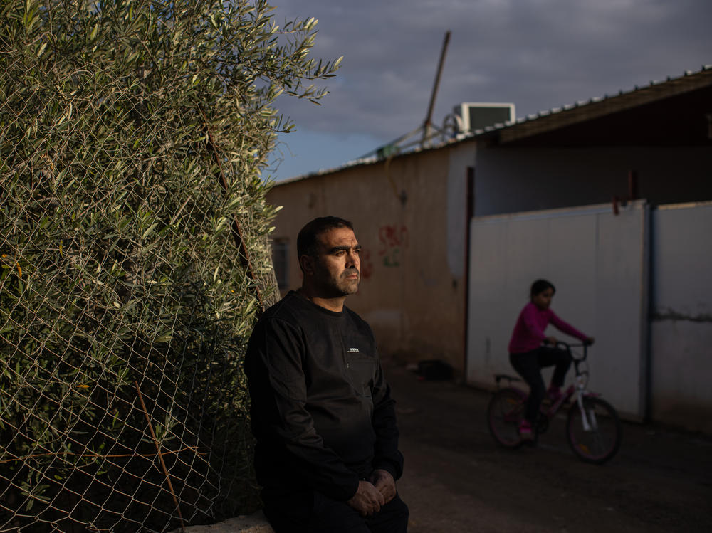 Mohammad Abu Queider stands near his home in al-Zarnuq, an unrecognized Bedouin village in southern Israel. His family has been caught in the crossfire twice: first during the Hamas attack and then in the Iranian strike.