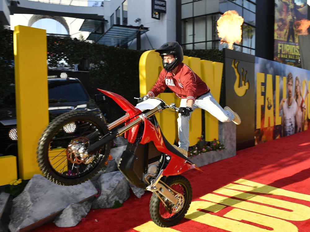 A stunt performer at the Los Angeles premiere of <em>The Fall Guy. </em>Outside the Dolby Theatre, another stunt artist jumped from atop a 45-foot crane, while others showed off a staged fight scene.