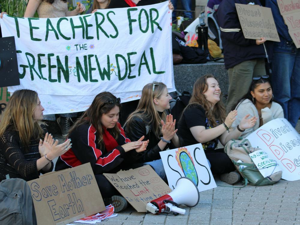 Ithaca residents called for officials to take action on climate change at a rally on Earth Day 2024.