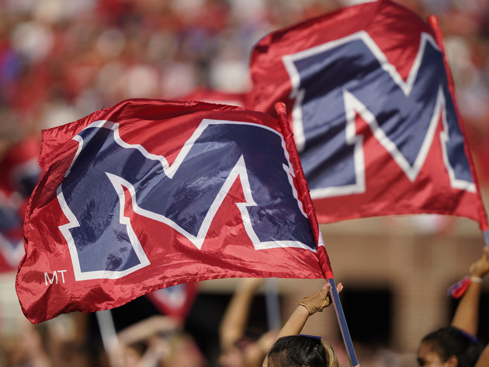 The University of Mississippi's school banner is waved during the pregame activities prior to the start of an NCAA college football game in October 2021. The university's leader denounced actions at a protest last week.