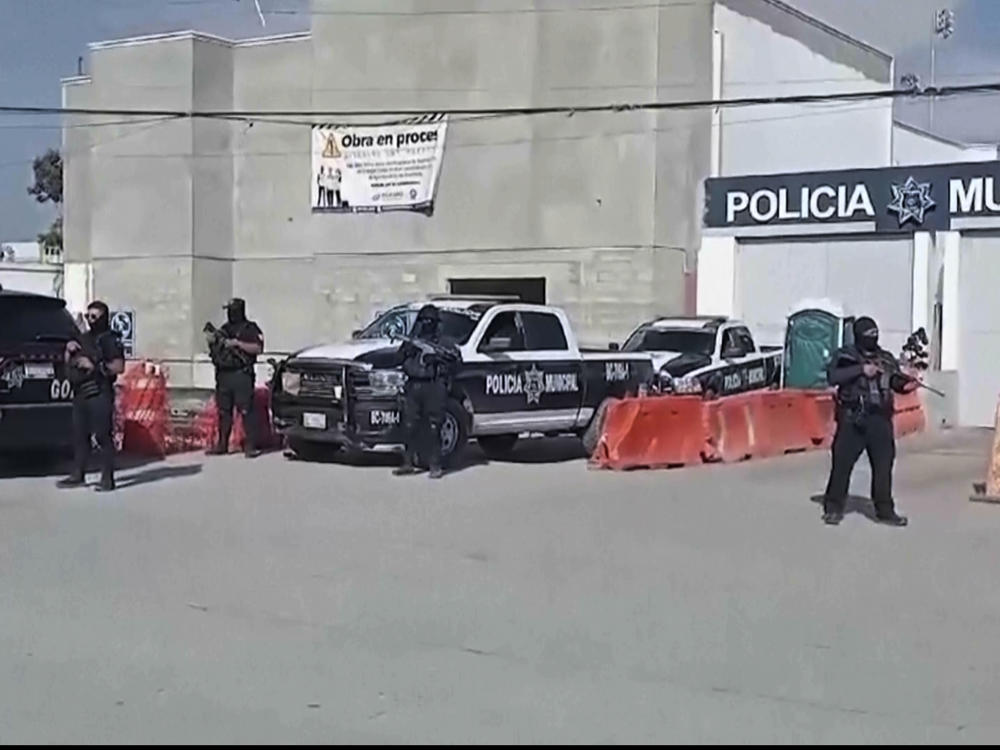 In this image made from video, Mexico's police officers stand guard at the Ensenada station in Ensenada, Mexico, Thursday, May 2, 2024.