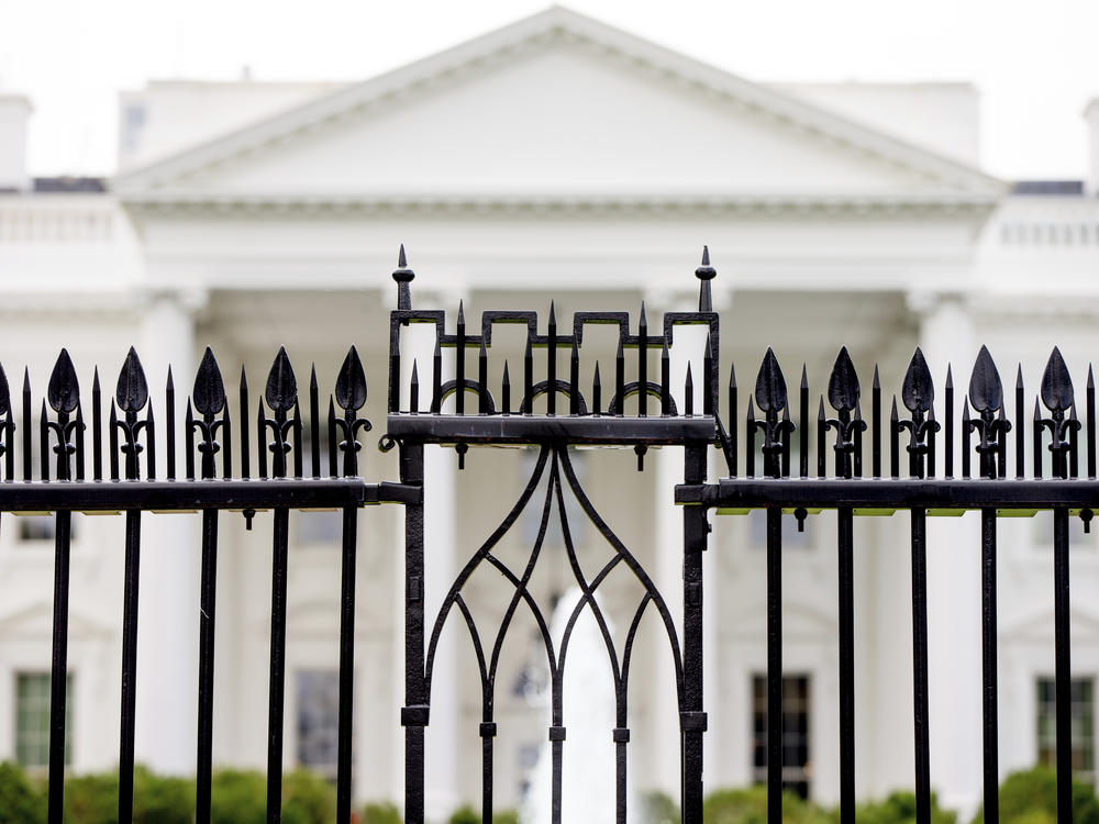 FILE - The White House is visible through the fence at the North Lawn in Washington, on June 16, 2016. A driver died Saturday night, May 4, 2024 after crashing a vehicle into a gate at the White House, authorities said.