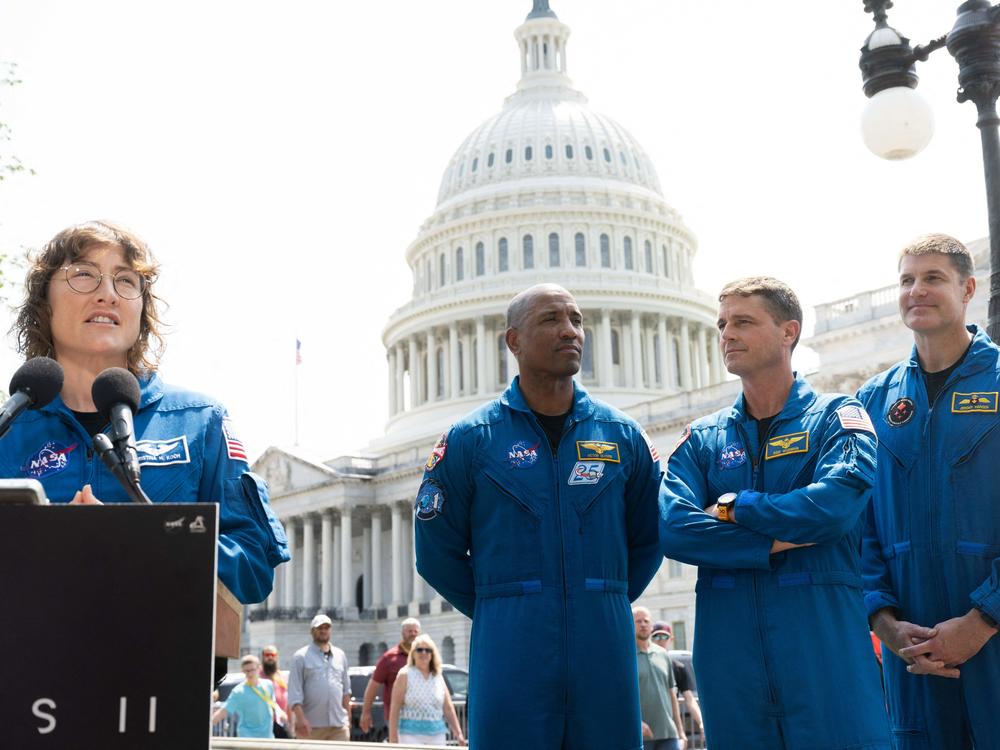 NASA Astronaut Christina Hammock Koch (L) speaks alongside fellow members of the crew of the Artemis II mission, with NASA astronauts Victor Glover (L) and Reid Wiseman (C), along with Canadian Space Agency astronaut Jeremy Hansen (R) outside the U.S. Capitol in Washington, D.C., on May 18, 2023.