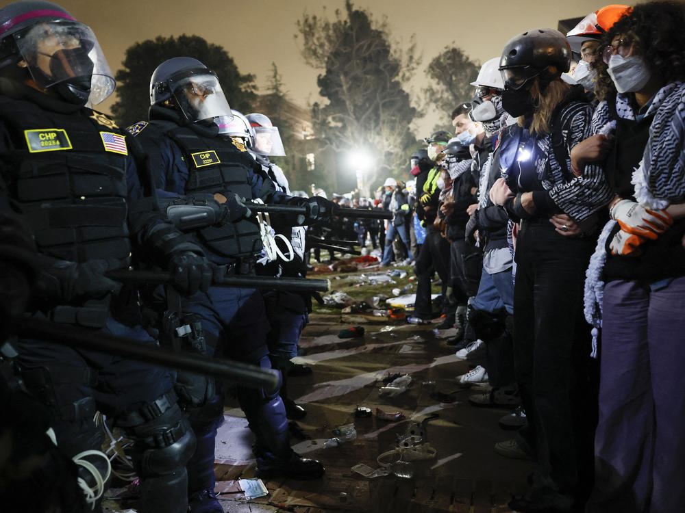 Police face off with pro-Palestinian students after dismantling part of the encampment barricade on the campus of the University of California, Los Angeles, early on May 2.