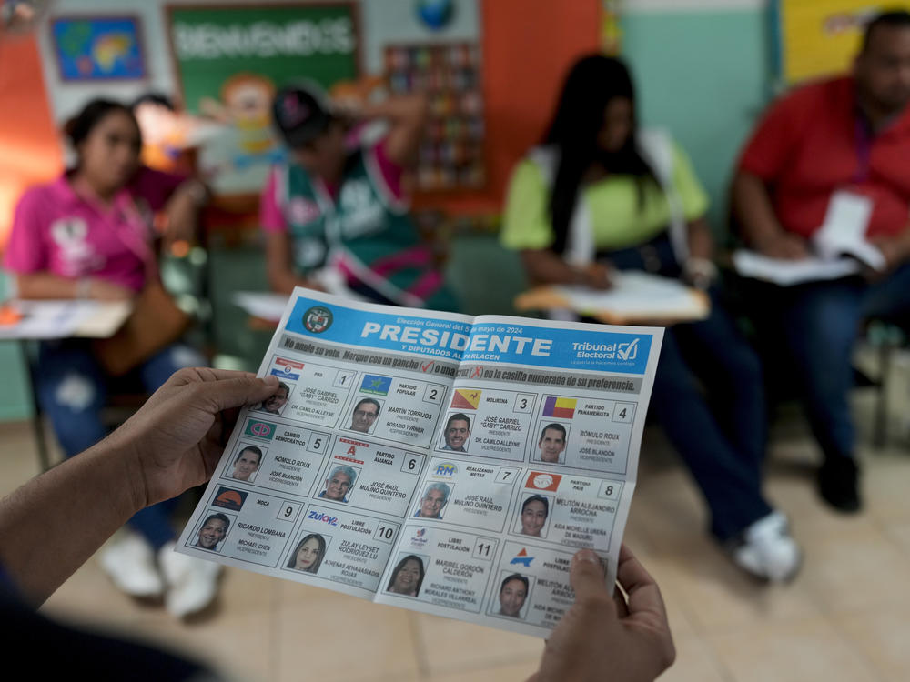 An electoral worker holds a ballot as he counts them after general elections polls closed in Panama City, on Sunday.