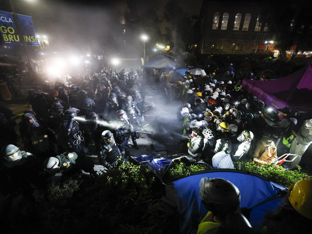 Police face off with pro-Palestinian students after dismantling part of the encampment barricade on the UCLA campus in Los Angeles early on May 2.