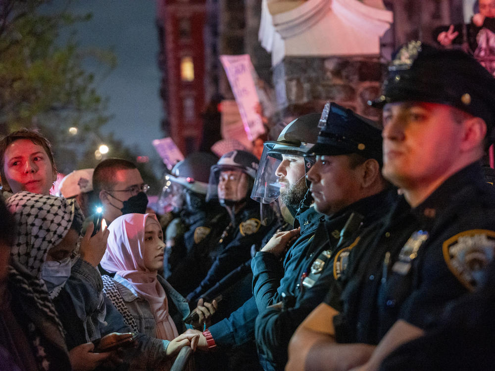 Pro-Palestinian supporters confront police during demonstrations at The City College of New York as the NYPD cracks down on protest camps at both Columbia University and CCNY on April 30, in New York City.