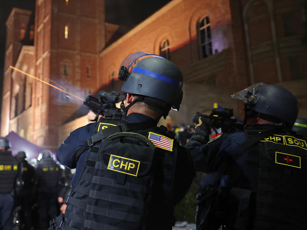 A California Highway Patrol (CHP) officer fires a flash-bang while clearing a pro-Palestinian encampment after dispersal orders were given at the University of California, Los Angeles (UCLA) campus, on May 2, 2024 in Los Angeles, California.