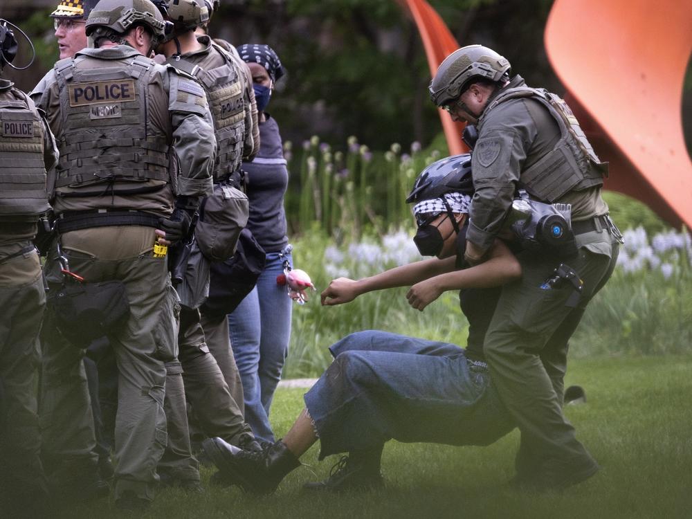 Police take demonstrators into custody on the campus of the Art Institute of Chicago after students established a protest encampment on the grounds on May 4.