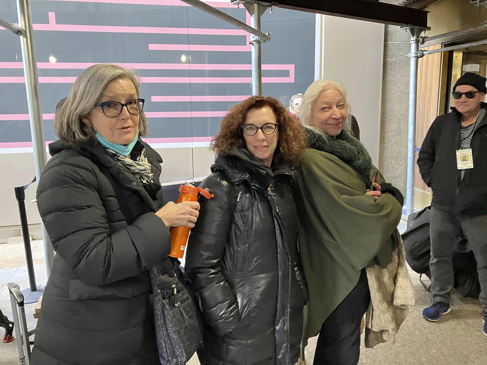 Courtroom sketch artists Elizabeth Williams (from left), Jane Rosenberg and Christine Cornell wait to enter the Manhattan courthouse where former President Donald Trump's trial is occurring on April 25.