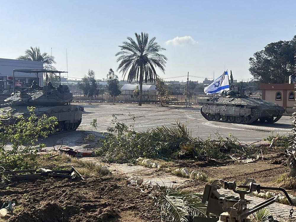 This photo provided by the Israel Defense Forces shows a tank with an Israel flag on it entering the Gazan side of the Rafah border crossing on Tuesday.