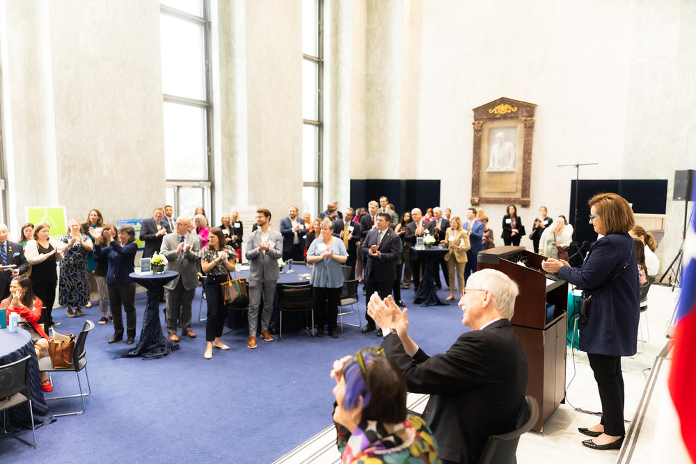 The Congressional Families Program at the Prevent Cancer Foundation hosted an event recognizing leaders on Capitol Hill on April 11, 2014. Lisa McGovern (on right on stage) stressed that spouses of lawmakers in both parties collaborate across the country.