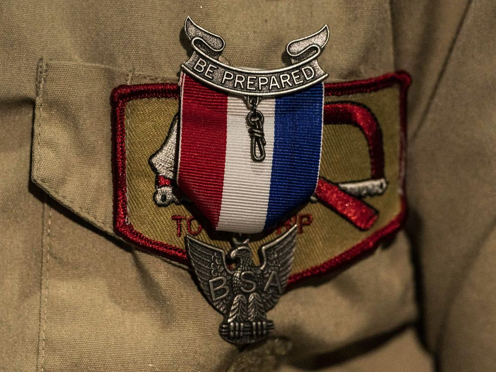 An Eagle Scout Award is seen pinned to a uniform. After a lengthy sex-abuse scandal and bankruptcy, the Boy Scouts are changing their name to Scouting America.