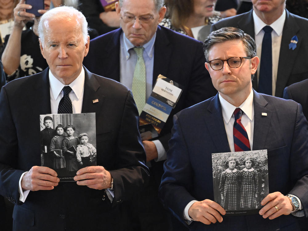 President Biden and House Speaker Mike Johnson hold images of Holocaust victims during the annual Days of Remembrance ceremony at the U.S. Capitol.