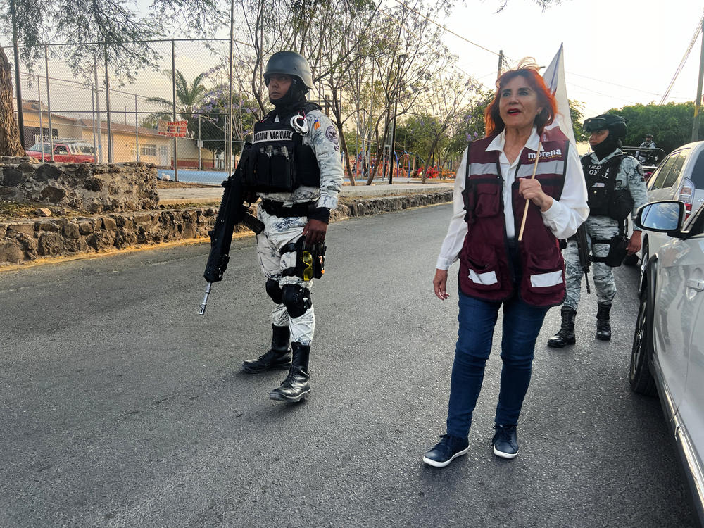 Following a rash of political assassinations, Magdalena Rosales campaigns with armed escorts in the city of Celaya in Mexico.