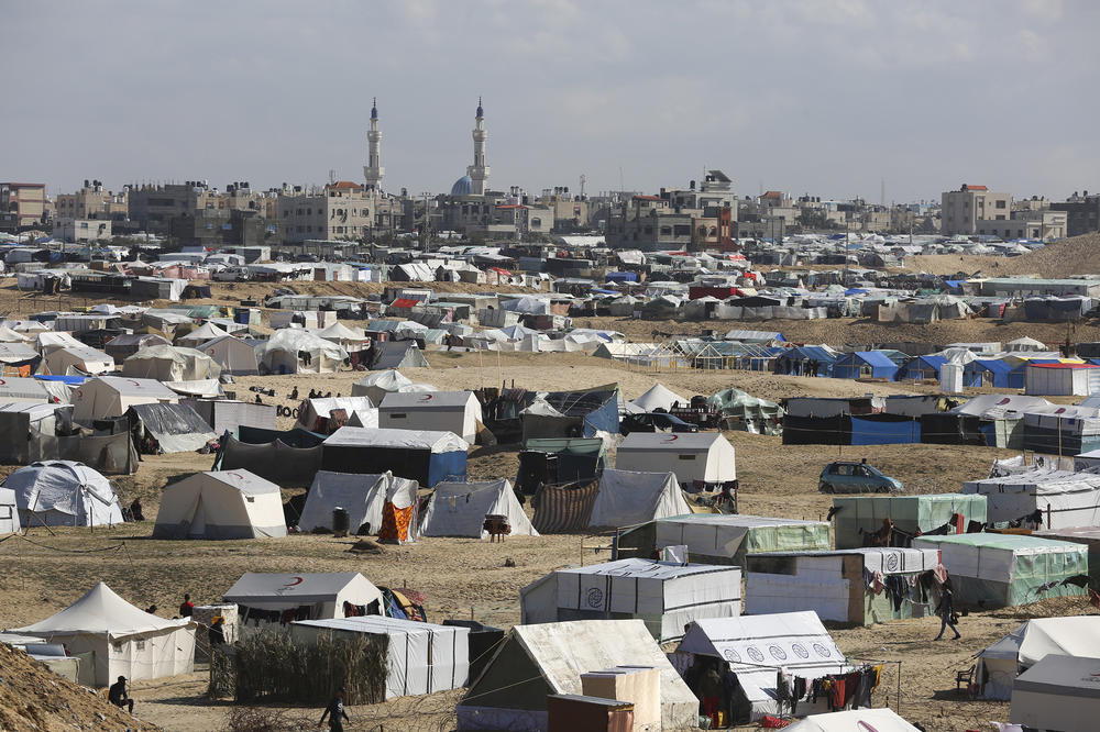 Palestinians displaced by the Israel air and ground offensive on the Gaza Strip take shelter near the border fence with Egypt in Rafah, Jan. 24, 2024.