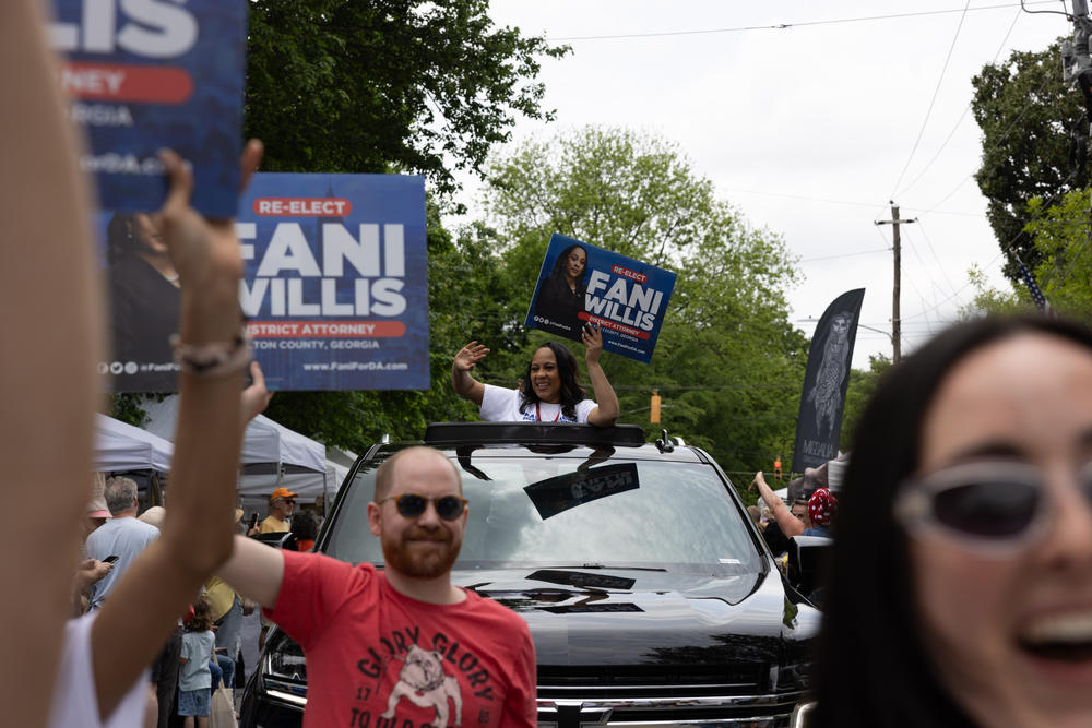 Fulton County District Attorney Fani Willis, a Democrat who's also up for reelection this month, is seen riding in an SUV at a parade in Atlanta on April 27. Willis regularly receives death threats, especially since she asked a grand jury to indict former President Donald Trump and his allies.
