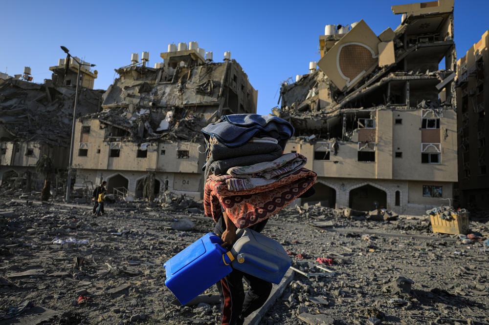 Residents leave the Hamad Towers area, taking some of their belongings with them after the Israeli attacks on Khan Younis, Gaza Strip, Dec. 2, 2023.