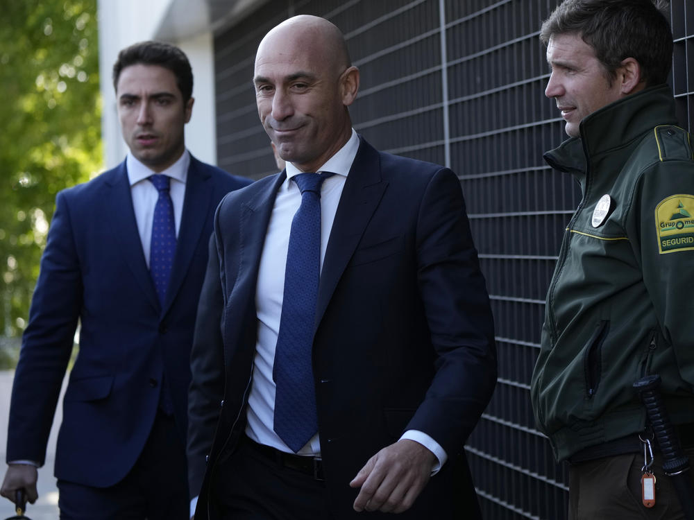 The former president of Spain's soccer federation Luis Rubiales (center) will stand trial for sexual assault charges after forcibly kissing soccer star Jenni Hermoso, a Spanish judge confirmed.