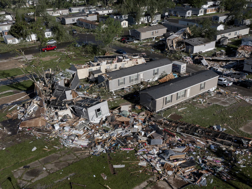 Storm damaged mobile homes are surrounded by debris at Pavilion Estates mobile home park just east of Kalamazoo, Mich., on Wednesday, May 8, 2024.