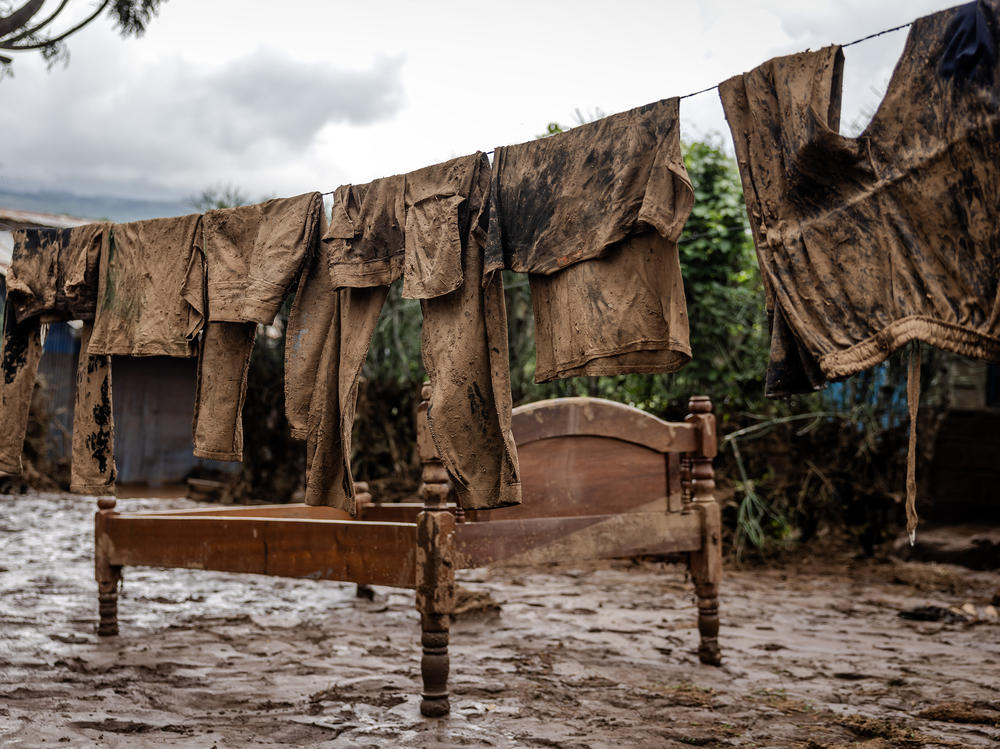 Clothing and furniture stand outside a house that was flooded in late April.