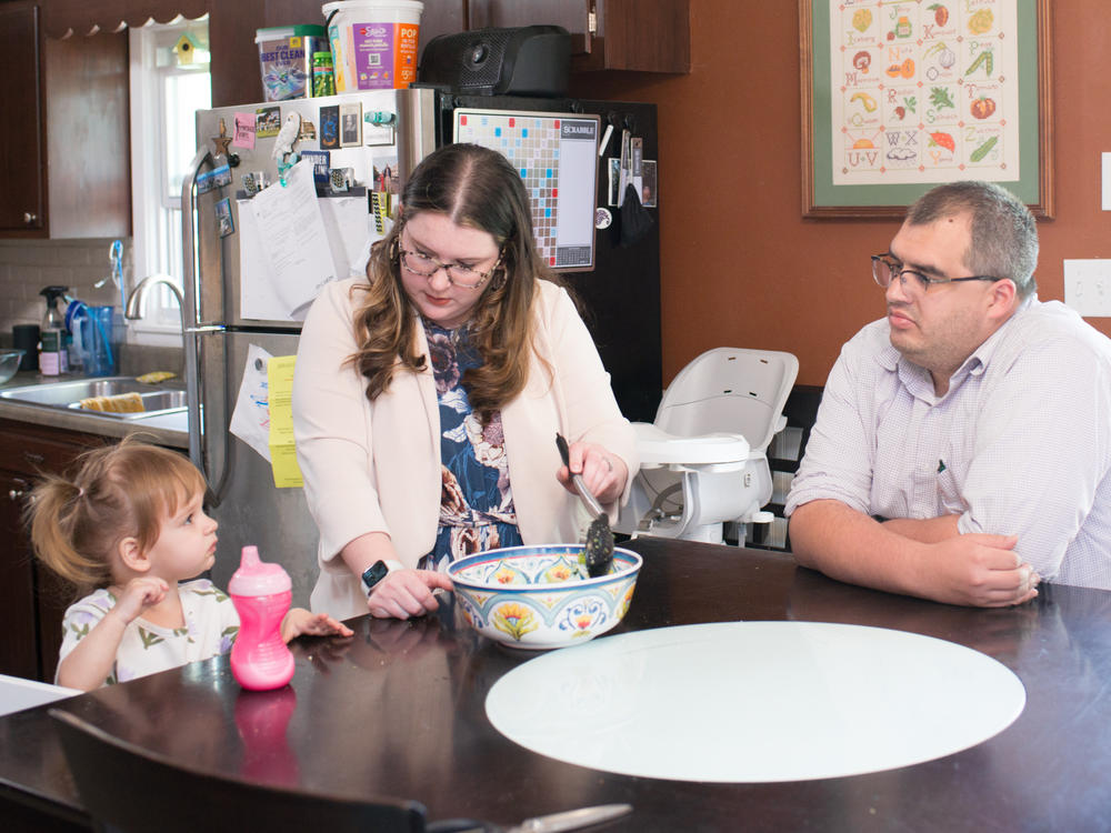 Medical debt is as much a hallmark of having children as long nights and dirty diapers. The Crivilare family, Andrew, Heather and Rita, 2, are pictured at their kitchen table in Jacksonville, Ill.