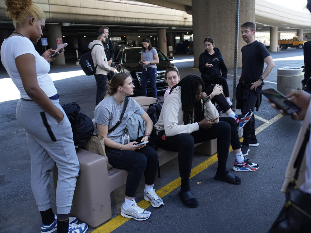 Players and staff of the New York Liberty WNBA basketball team wait to board buses at Harry Reid International Airport, Wednesday, June 28, 2023, in Las Vegas.