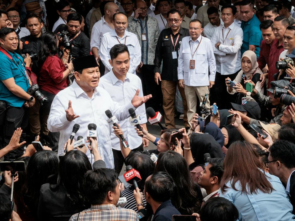 Indonesia's President-elect Prabowo Subianto (left) speaks to reporters with Vice President-elect Gibran Rakabuming Raka (second left) as they arrive at the plenary session of the General Elections Commission after his main rivals' challenges to his election victory were rejected in Jakarta, April 24.