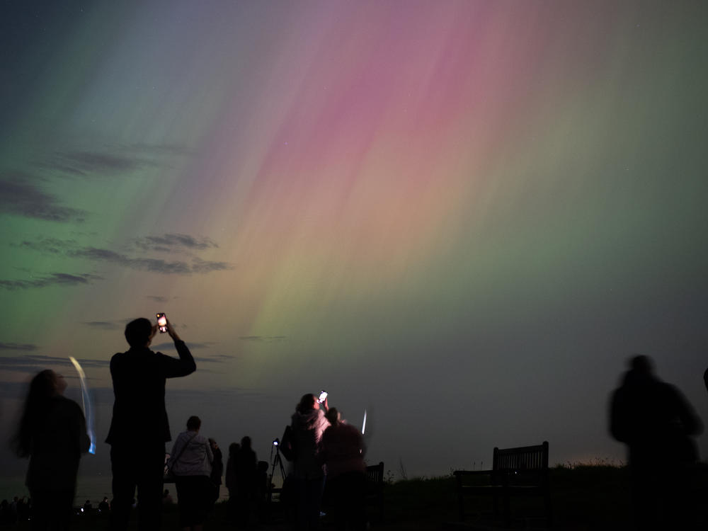 People visit St Mary's lighthouse in Whitley Bay to see the aurora borealis on Friday in Whitley Bay, England.