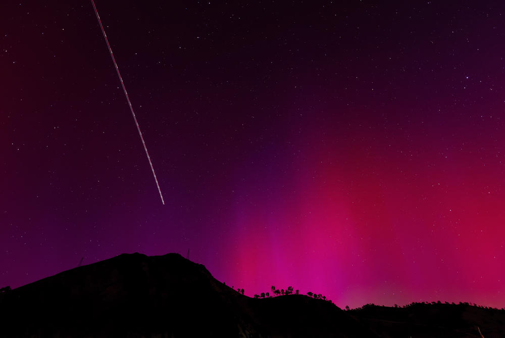 Lake Berryessa, Calif.: The blinking lights of a plane streak through the aurora borealis, also known as the northern lights, which is visible on May 11, 2024.