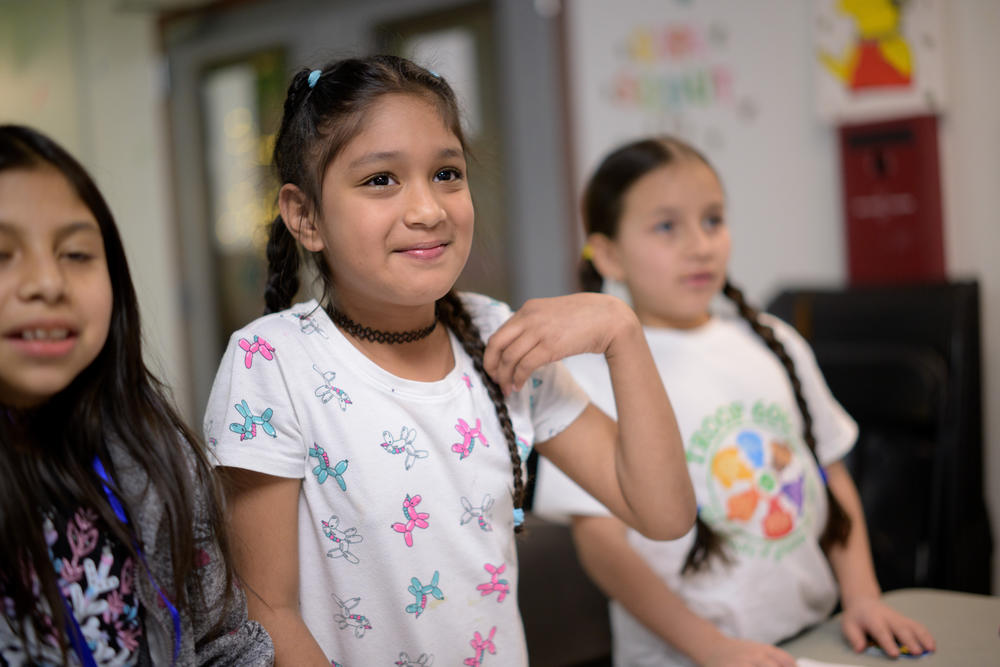 Alicia smiles while the troop plays bingo during a Girl Scout Troop 6000 meeting.