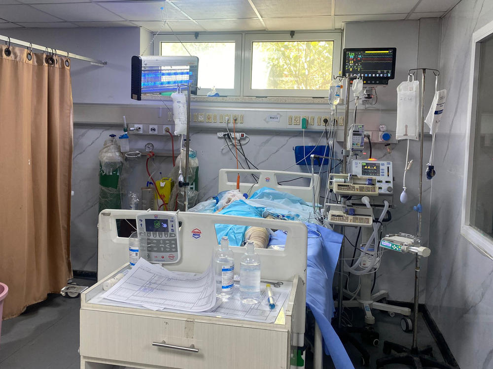 A patient in European Gaza hospital this weekend — the last functioning hospital in Rafah. Staff placed an insect zapper above his bed to keep away the flies.