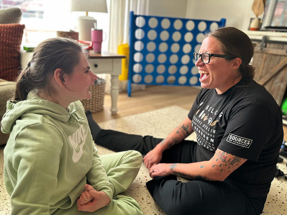 Emma Lenover, left, works through a literacy lesson at home with special education teacher Sarah Elston. Emma loves these visits and, on this day, waited anxiously at the picture window for Elston to arrive.
