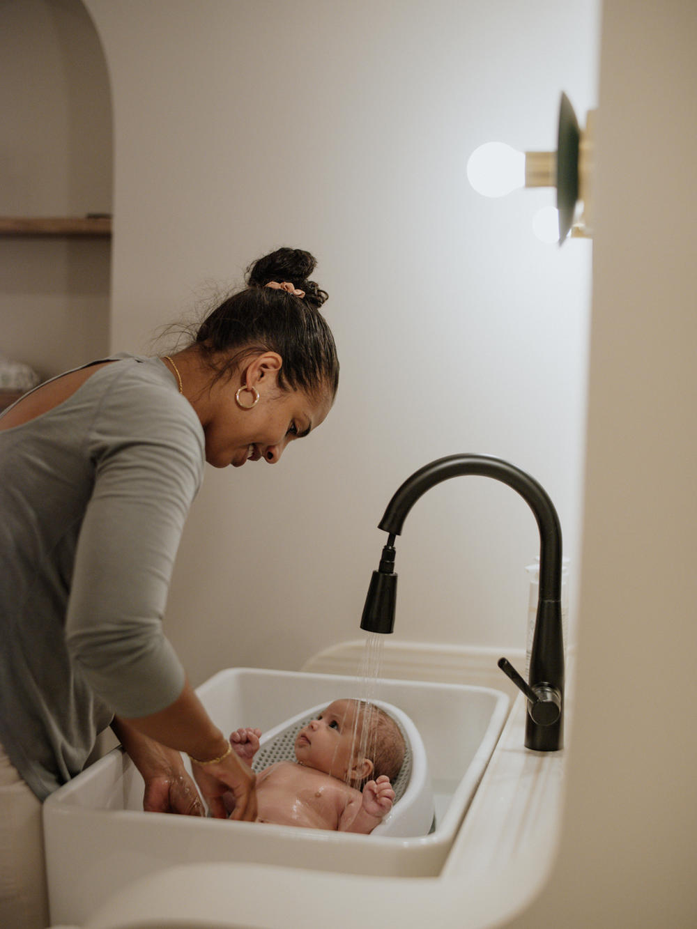 Sara Hutchins bathing her daughter.