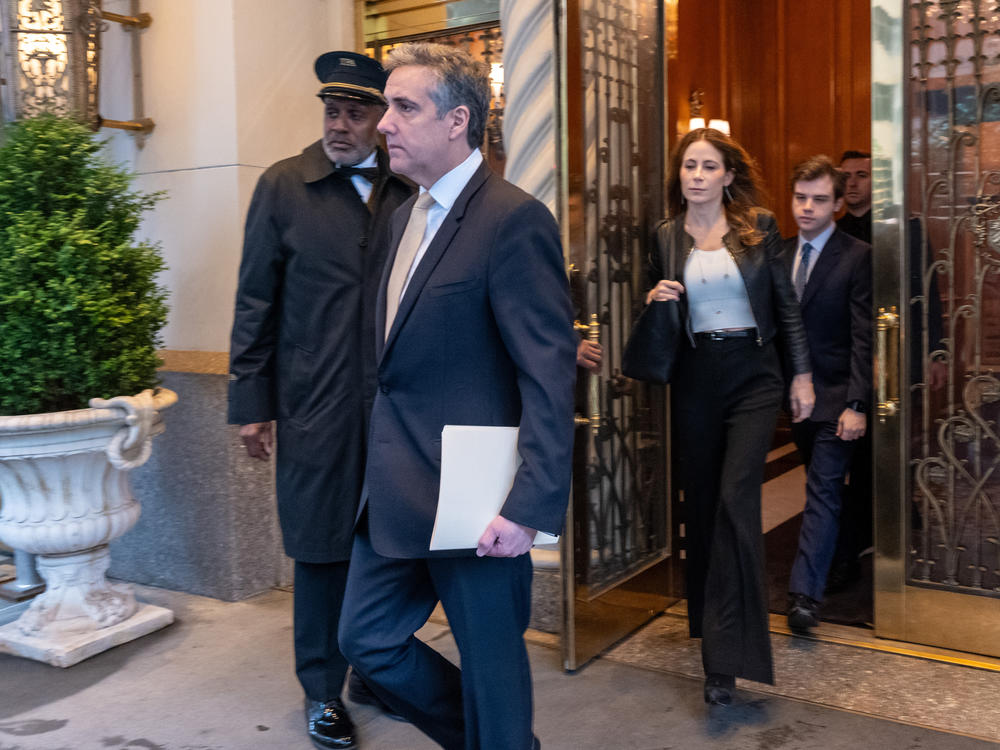 Michael Cohen, former personal lawyer to former President Donald Trump, and attorney Danya Perry leave his apartment building on his way to Manhattan Criminal Court in New York City on Thursday.