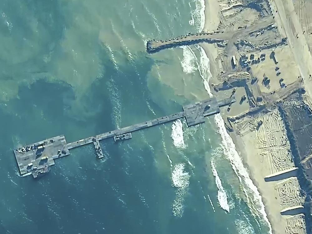 The image provided by U.S, Central Command, shows U.S. Army soldiers, U.S. Navy sailors and Israel Defense Forces placing the Trident Pier on the coast of Gaza Strip on Thursday.