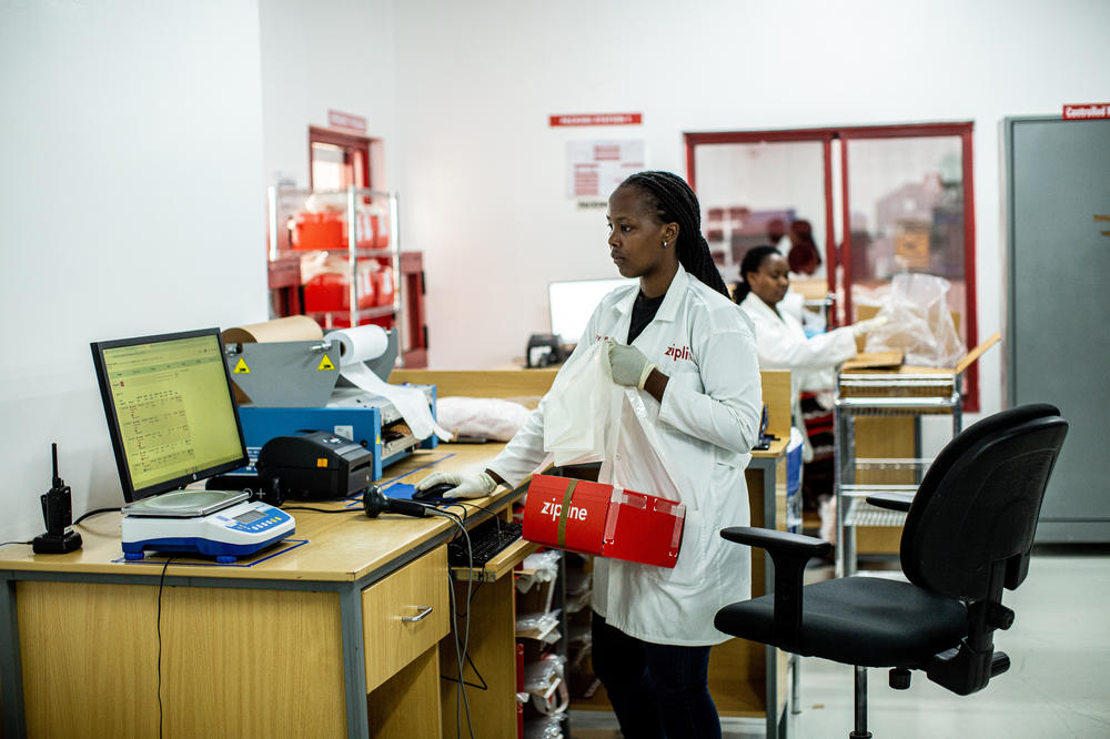 Zipline workers pack and send drones off to hospitals.