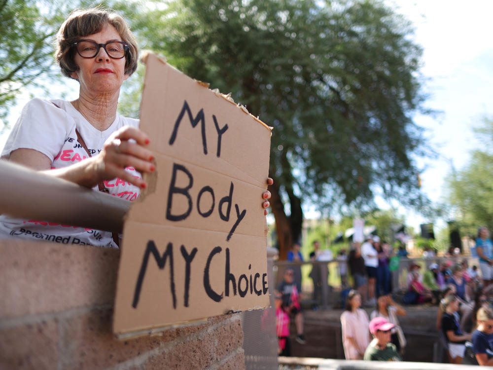 A protestor attends a Women's March rally in Phoenix, Arizona in 2022.