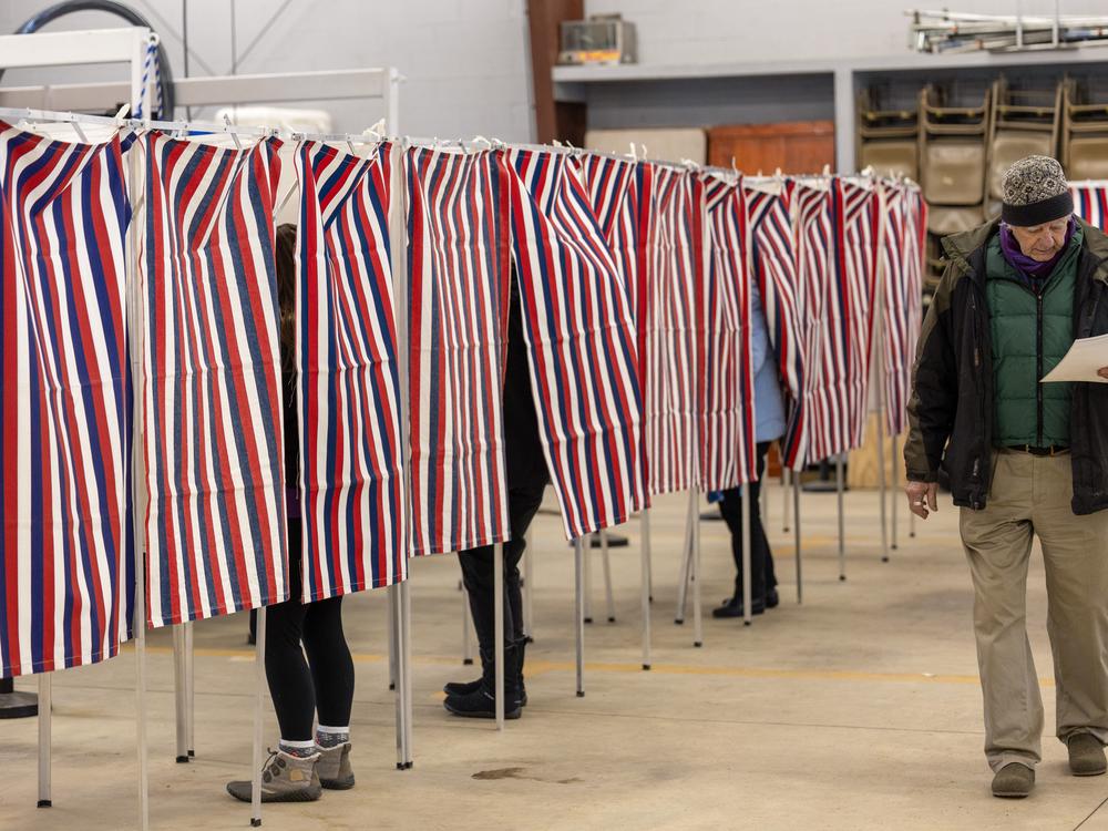 Voters filling out their ballots on Jan. 23 in Loudon, N.H. A political consultant faces charges in New Hampshire and steep fines from the Federal Communications Commission for creating a robocall ahead of that state's presidential primary featuring a cloned version of President Biden's voice, urging people not to vote in the primary.