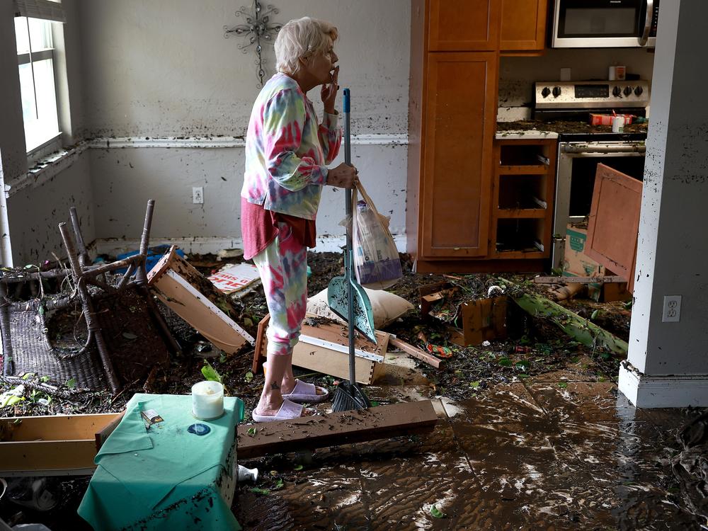 Hurricane Ian killed more than 150 people when it slammed into Florida in 2022. Here, Fort Myers, Fla., resident Stedi Scuderi looks over her apartment after it was inundated by flood water from the storm.
