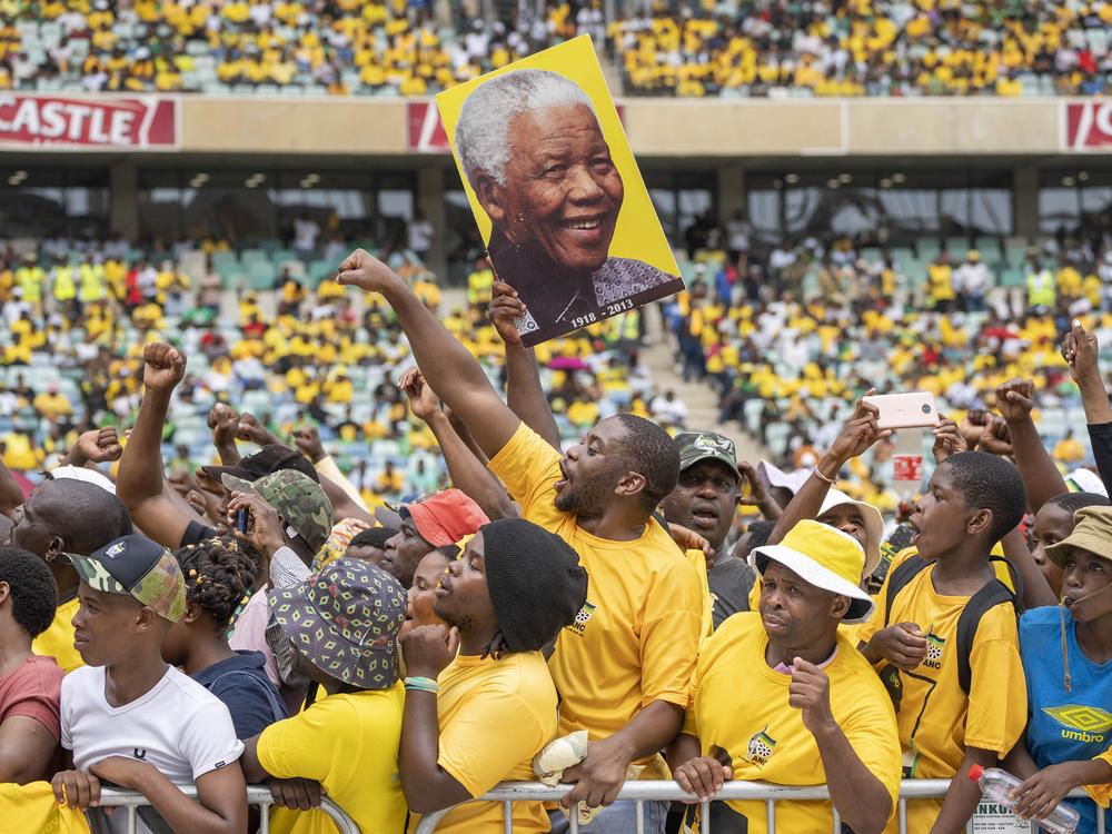 African National Congress supporters, one holding a portrait of Nelson Mandela, gather at the Mose Mabhida stadium in Durban, South Africa, Feb. 24, for their national manifesto launch in anticipation of the 2024 general elections.